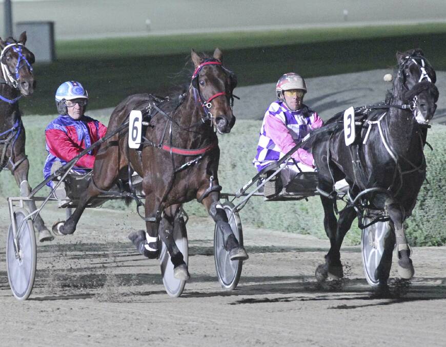 HOLDING ON: Shadow Sax (Gavin Lang), left, holds out Brallos Pass in THE Vicbred Super Series final for 2yo colts and geldings at Melton. Picture: Harness Racing Victoria