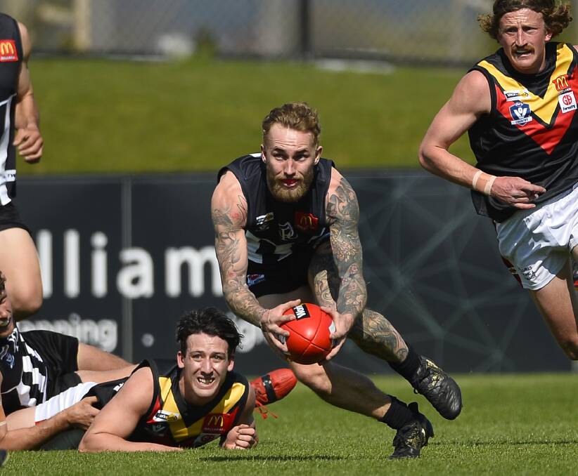 OFF AND RUNNING: Darley's Jacob Zeestraten keeps his feet and charges away, while all grounded Liam Noonan can do is watch on. Pictures: Dylan Burns.
