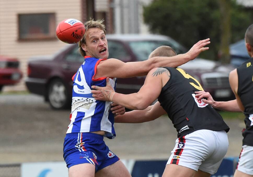 BIG BATTLE: East Point veteran Paula Koderenko gets in a tangle with his Bacchus Marsh counterpart Daniel Burton. Picture: Lachlan Bence