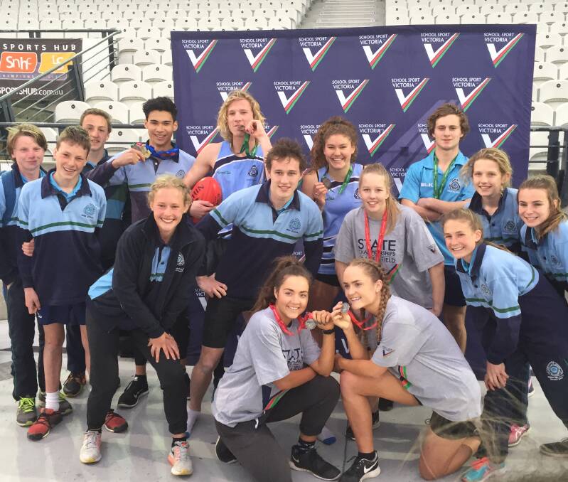 BIG DAY OUT: some of  the members of the Ballarat High School team, which finished fourth overall on aggregate, celebrate at the end of the meet at Lakeside Stadium, Albert Park. 