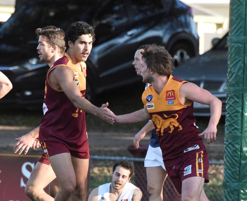 Keenan Waterbury, left, congratulates Mitch Phelps after one of his six goals against Melton South. Picture: Lachlan Bence