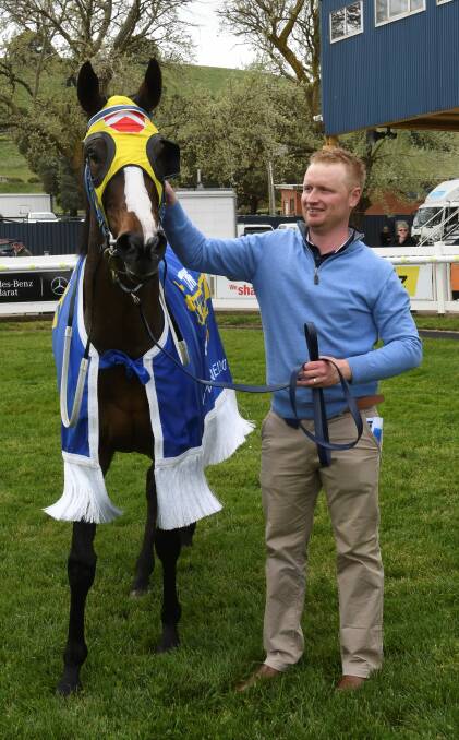 BIG DAY: co-trainer Trent Wells celebrates with Woohoo after her maiden-breaking performance. Picture: Lachlan Bence.