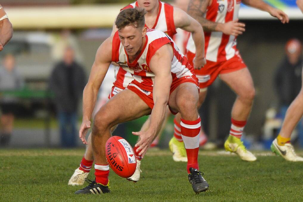 ON THE BALL: Grant Baldwin swoops on the football in his Ballarat Swans senior debut against Lake Wendouree on Saturday. Picture: Dylan Burns