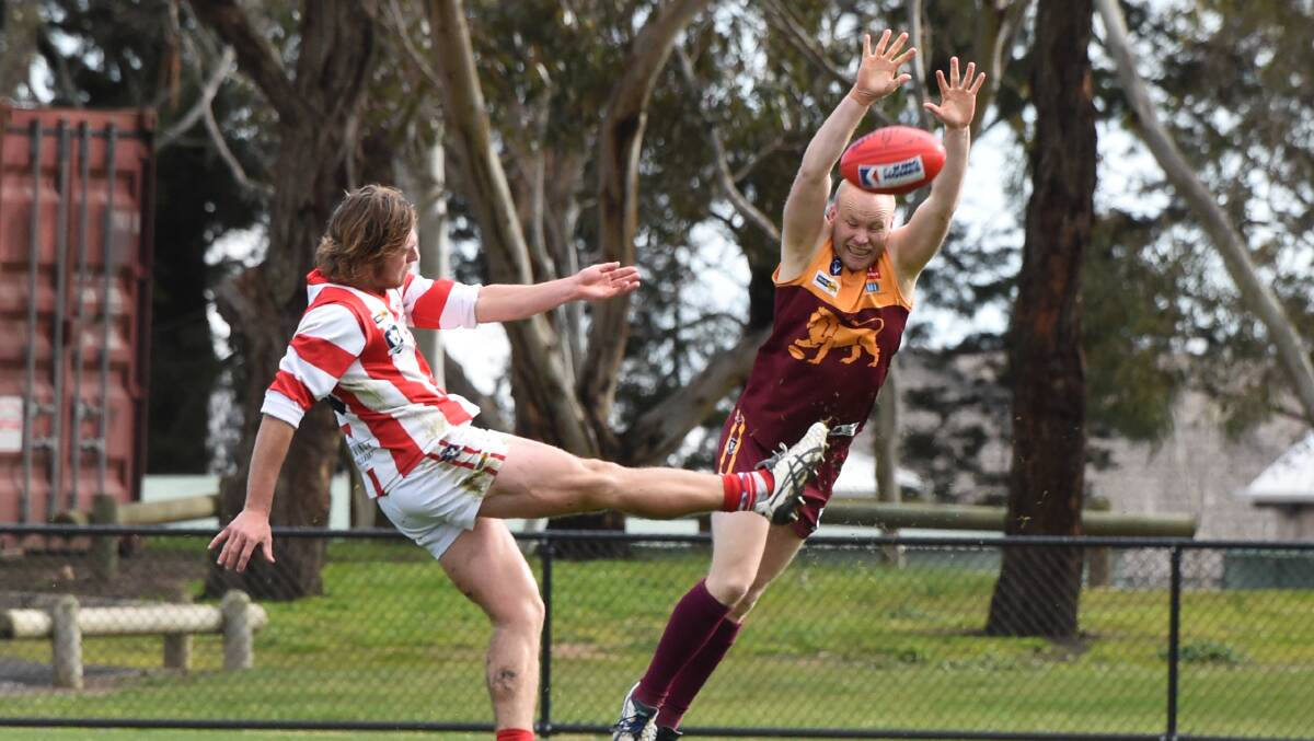 Brenton Riordan (Redan) tries to smother a kick by Liam Youl (Ballarat). Picture: Lachlan Bence.