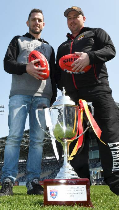 SILVERWARE: coaches Heath Scotland (Darley) and Travis Hodgson (Bacchus Marsh) eye the premiership cup at Mars Stadium on Wednesday. Picture: Lachlan Bence