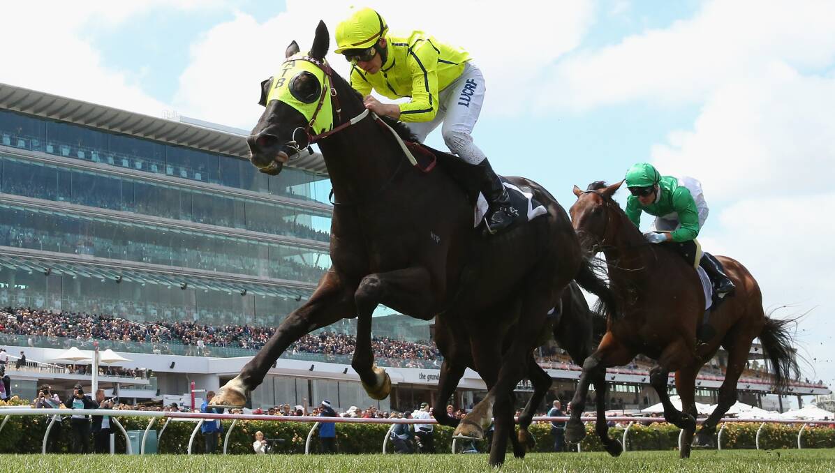 GAME OVER: Dandino (Ben Melham) races to victory in the Queens' Cup at Flemington in the Melbourne Cup Carnival. Picture: Getty Images
