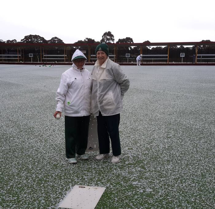 BEATEN BY ELEMENTS: Webbcona’s Jenny Shepherd and Helen Williams rugged up on a hail-covered green at Creswick.  