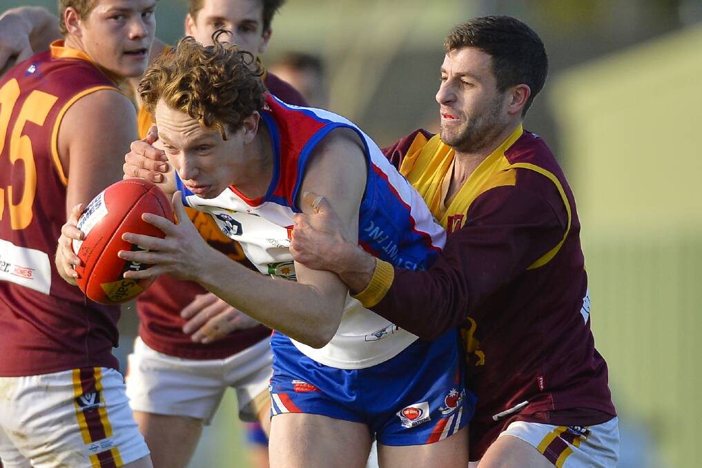 Redan's Nathan Horbury tackles Hasker Dawborn (East Point) at the Eastern Oval. Picture: Dylan Burns