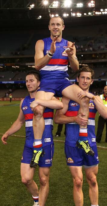 LAST TIME: Daniel Cross is carried off the ground after his last game with the Western Bulldogs in 2013. He is now bowing out for the Demons. Picture: Getty Images 