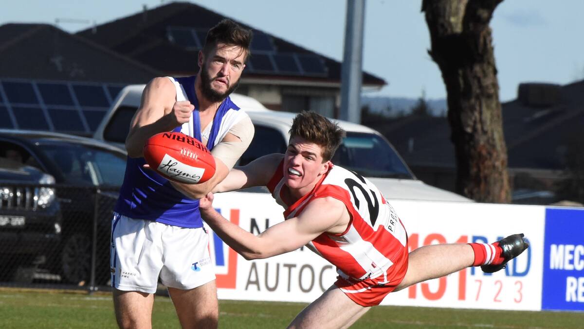 Dwain Sanderson (Sunbury) and Jack Sutherland (Ballarat Swans) go at it at Alfredton. 
Picture: Lachlan Bence