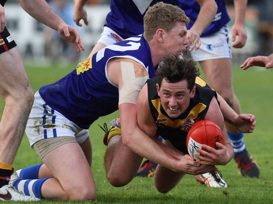CAPTAIN COURAGEOUS: Tyson Shea throws himself into the game against the bigger body of Sunbury's Joe Redfern. 