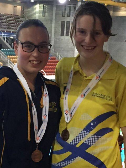 ON THE PODIUM: Ruby Halliday, left, and Anna Leighton with the bronze medals from the national age swimming titles.    