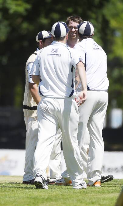 PROMISING: Andy Vandebyl is congratulated by Mt Clear teammates after claiming one of his two wickets on debut against Ballarat-Redan at the City Oval. Picture: Luka Kauzlaric