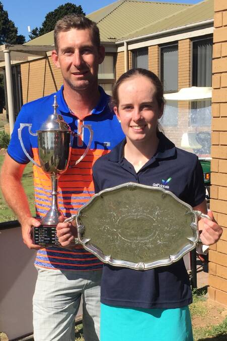 SILVERWARE: Sean Klain and Amy Leeson with the Ballarat District golf 54-hole tournament perpetual trophies.
