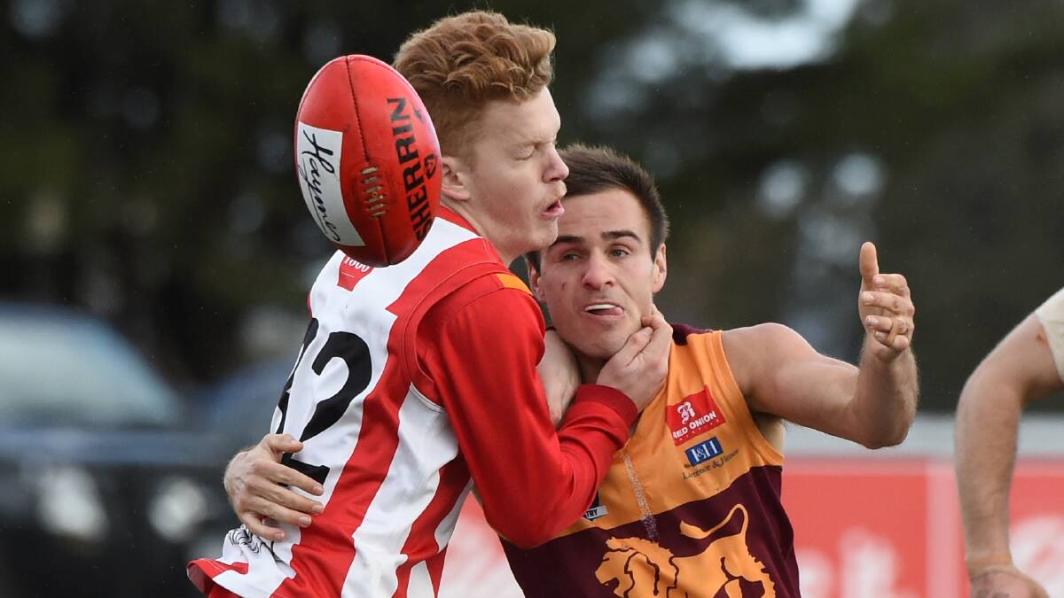 Toby Fisher (Ballarat) catches Chris Giampaolo (Redan) high. Picture: Lachlan Bence.