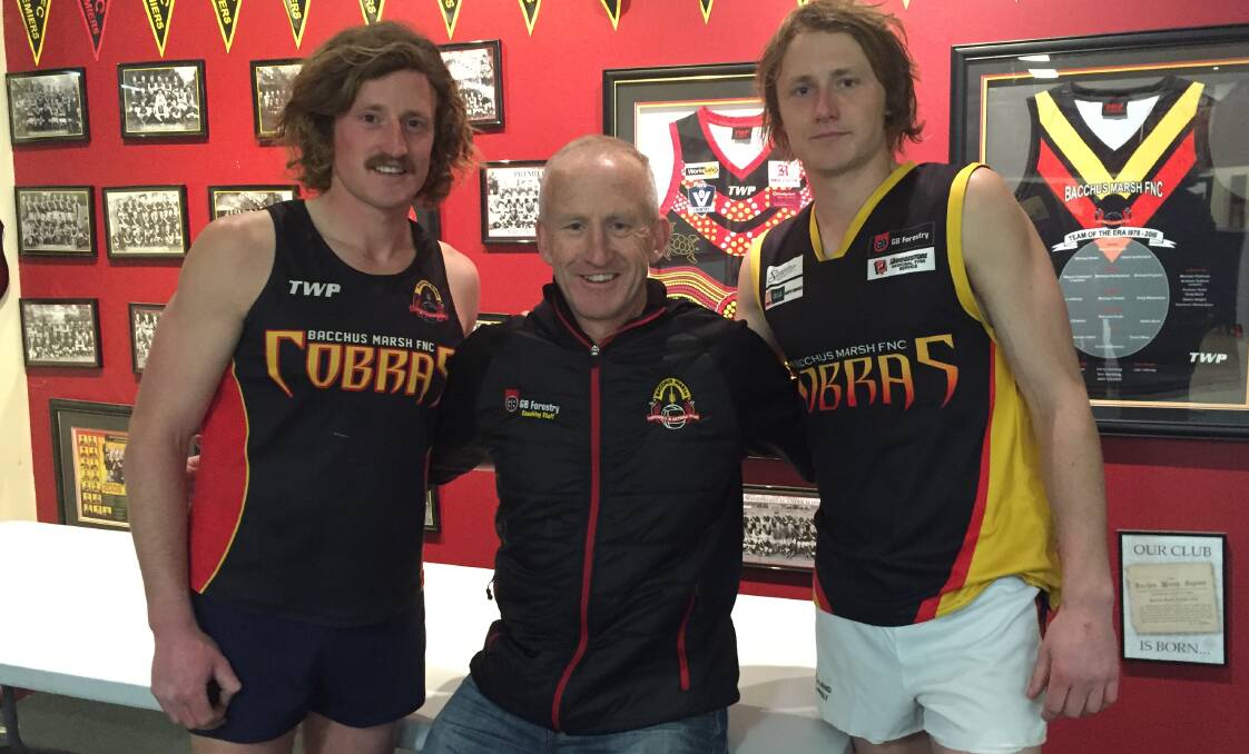 FAMILY AFFAIR: Michael Phyland with sons Declan and Lachlan, who are hoping to be members of Bacchus Marsh's first BFL premiership team.