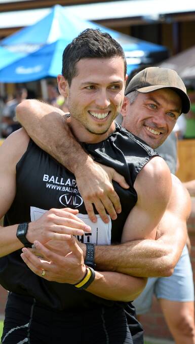 THE MOMENT: Noddy Angelakos is embraced by his coach Paul Tancredi after winning the Ballarat Gift on Sunday. Picture: Dylan Burns 