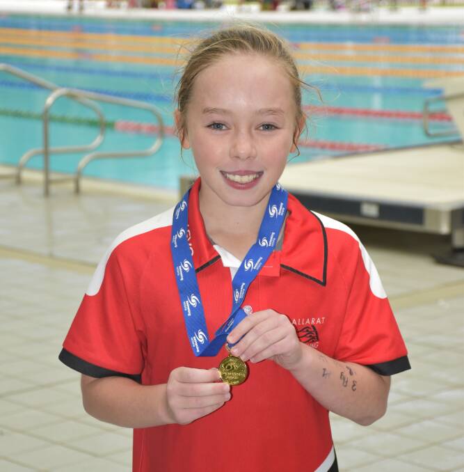 GOLDEN TOUCH: Ballarat Swimming Club's Ava Candy with her gold medal from the nine-year girls 50m breaststroke at the Victorian Country all junior meet.