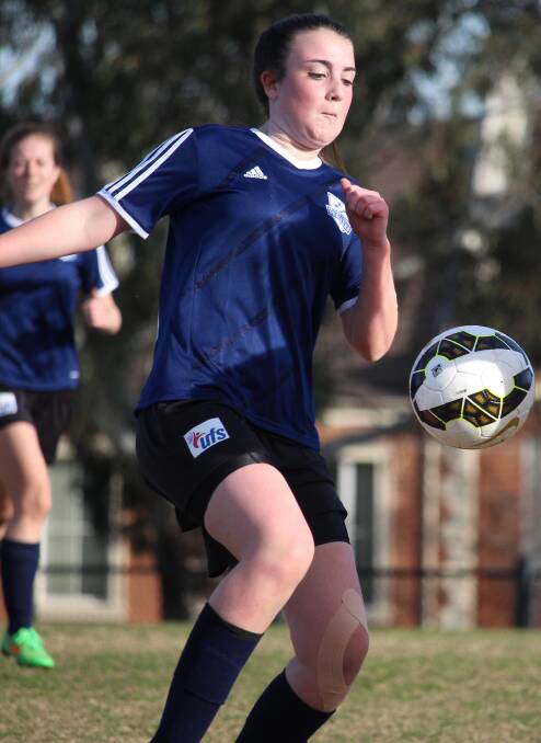 FOCUS: Lily McLean (Strikers) tries to control a bouncing ball.  