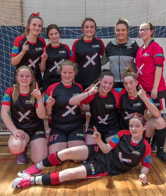 WINNERS: the Mt Clear College girls' team gives a victory salute after taking out a School Sport Victoria futsal event in Ballarat. 