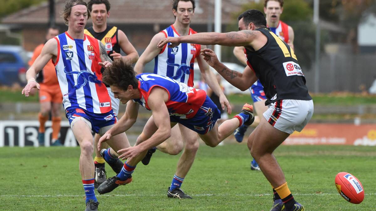 LOW FLYING: Aden Nestor (East Pont) loses his footing in this contest with Trent Angwin(Bacchus Marsh) at the Eastern Oval. Picture: Lachlan Bence.