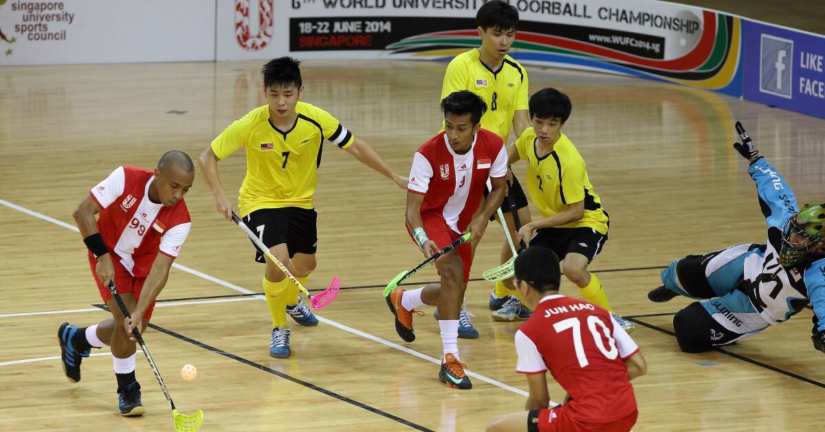 ONE THE BOARDS: Singapore and Malaysia do battle in a floorball match at a world university championship. Picture: Getty Images 