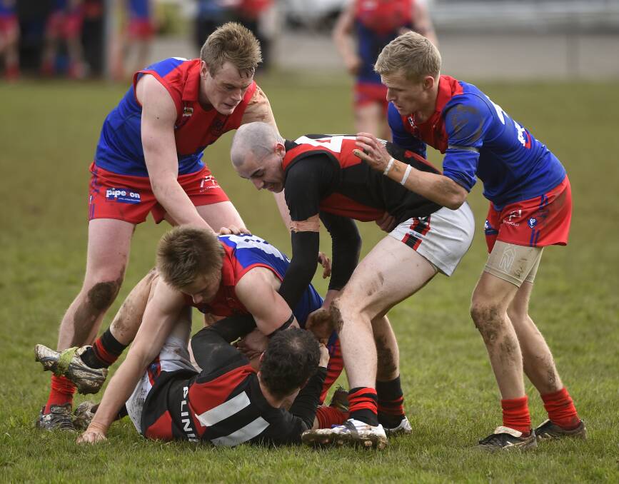 TANGLE: Tristan Simons (Bungaree) and Josh Mann (Buninyong) fight for the ball during the Demons' impressive win over the Bombers on Saturday afternoon. Picture: Luka Kauzlaric. Story: John McGregor.