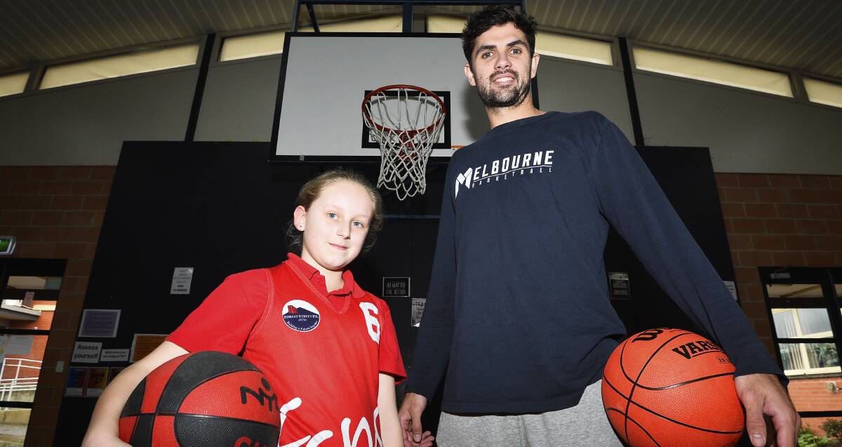 VISIT: Melbourne United forward Todd Blanchfield with Forest Street Primary School pupil Mackenzie Archer-Jeffrey during a visit on Thursday. Photo: Dylan Burns