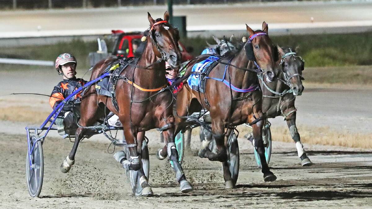 TOUGH: Soho Tribeca (Greg Sugars) works his way past Shadow Sax in the Kilmore pacing Cup. Picture: Stuart McCormick, Harness Racing Victoria