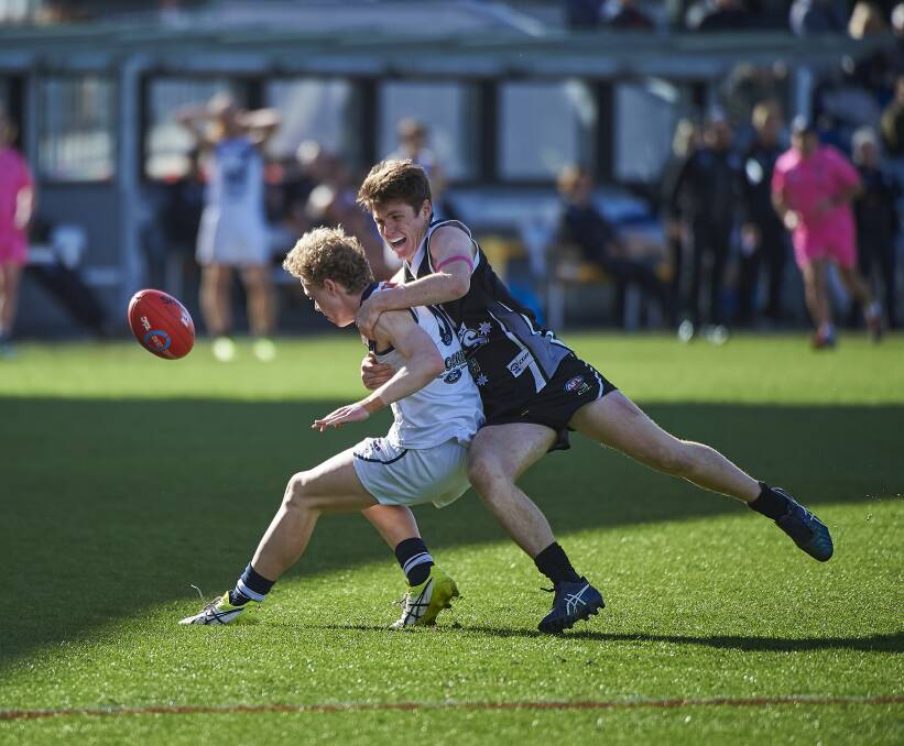 WRAPPED UP: Geelong Falcons ensure Tom Morrish has his path to the football blocked. Morrish was among GWV Rebels' best players. Picture: Luka Kauzlaric 