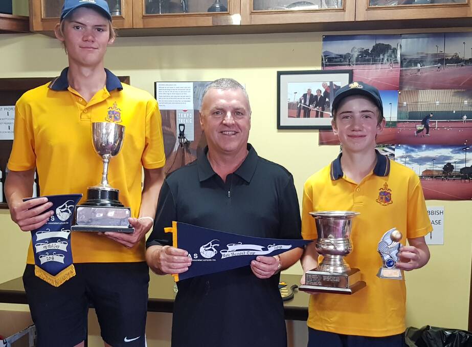 SILVERWARE: Ballarat Grammar School's BAS boys' singles title winners Tim McConchie (seniors), left, and James O’Sullivan (juniors) with Rob Benoit. 