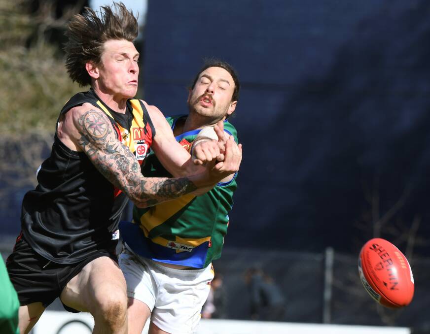 CRUNCH TIME: Rhys McNay just gets the ball away before a late challenge from Lake Wendouree defender Sam Clifton. Pictures: Lachlan Bence