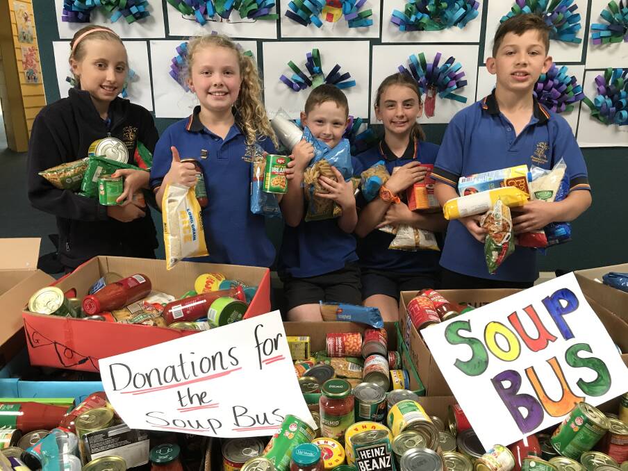 WELL-STOCKED: Pleasant Street Primary School junior school councillors Kate, Taylah, Jett, Kate, Nash with the groceries donated for Soup Bus. Picture: Michelle Smith