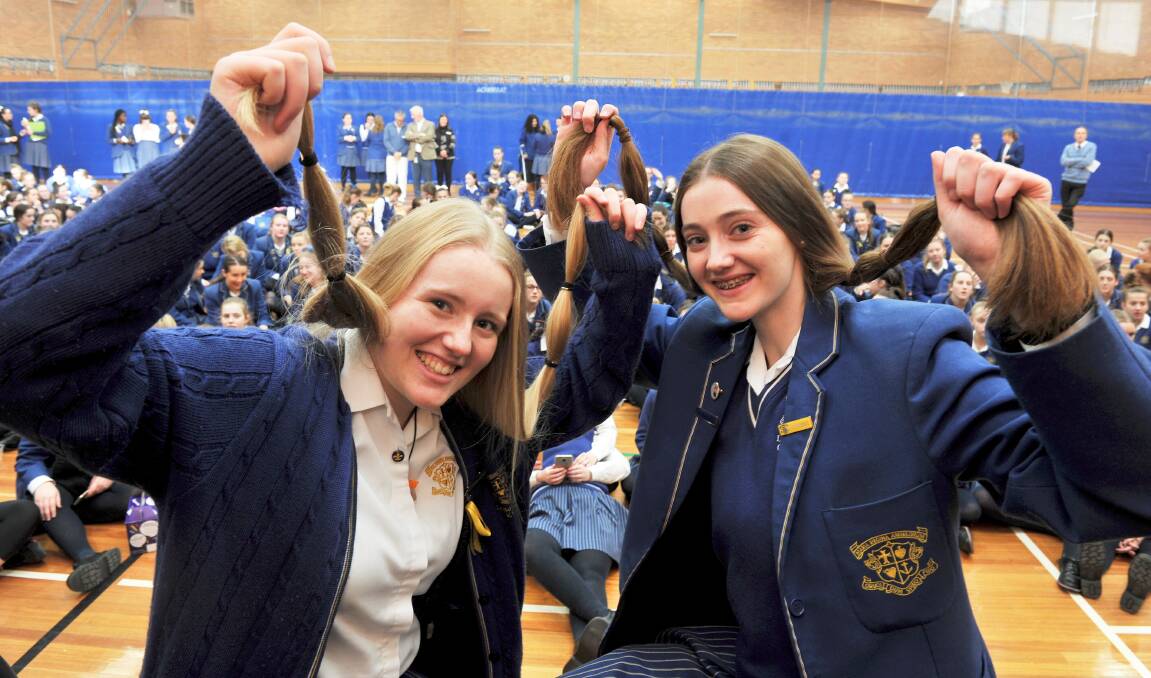 CHOPPED: Loreto students Gabby Wren and Maddy Davey before having their long hair cut for Variety to make wigs for children with cancer. Picture: Lachlan Bence