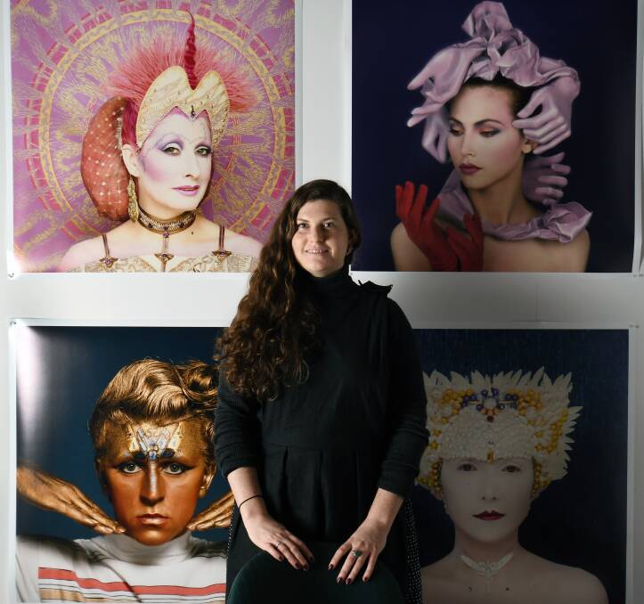 FACES: Curator Michelle Mountain with the faces of the Reverie Revelry: Fashion through Photography exhibition at the Ballarat Mechanics Institute. Picture: Kate Healy