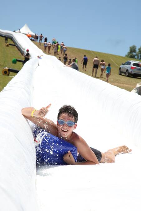 WET AND WILD: Slideapalooza at Myrniong's St Anne's Winery will see participants splash and slip down hills on at least 20 inflatable waterslides next February. 