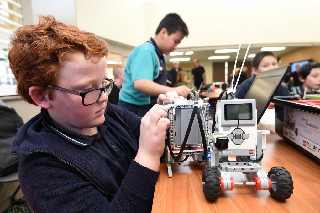CONCENTRATION: Caledonian Primary School pupil Jonah, 11, makes some adjustments to his robot for the Robo Cup Junior Ballarat event. Picture: Lachlan Bence.