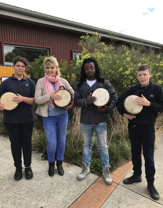 CHANGING LIVES: Charli, 11, Mary Coulson, Marvine Gaye and Jordan, 14, drum up support for Restart Africa at Yuille Park Community College. Picture: Michelle Smith
