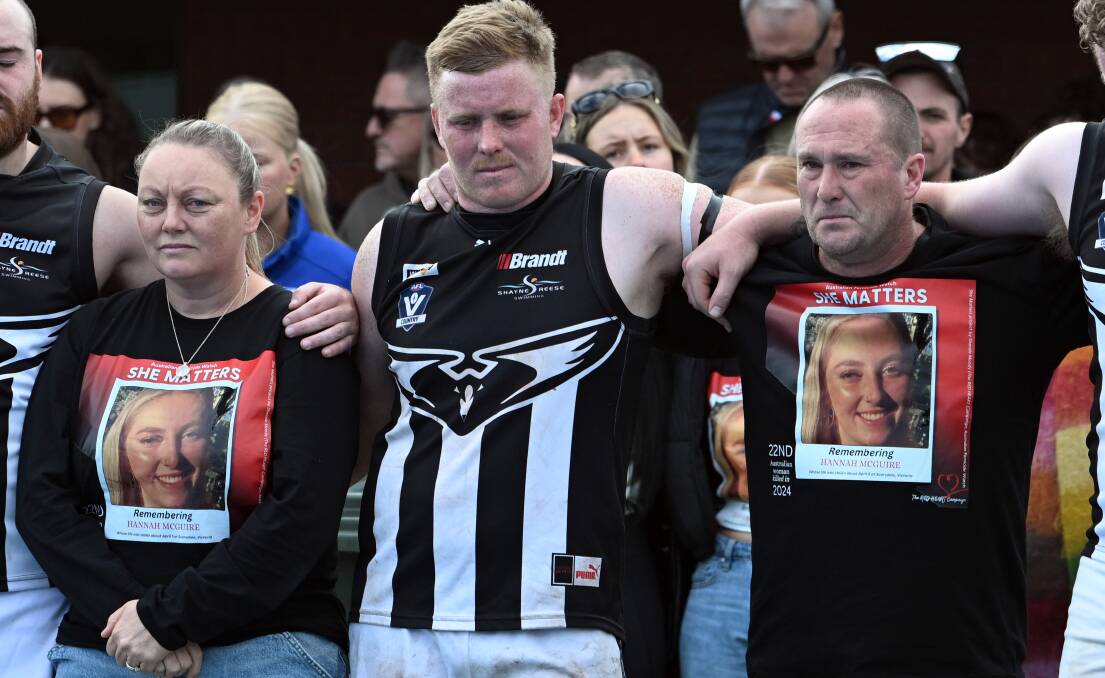 Hannah McGuire's parents Debbie, left, and Glenn, right, at a memorial and minute's silence for their daughter during football and netball matches between Clunes and Waubra in Waubra on Saturday. Picture by Kate Healy