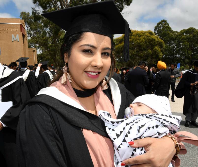 NEW MUM: Inderpreet Kaur Mangat and her son Gavin Singh, seven weeks, after her graduation. Picture: Lachlan Bence