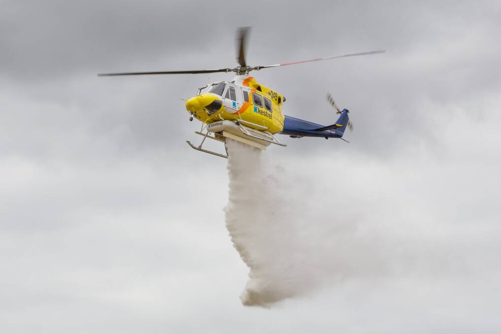 WATER DROP: The new Bacchus Marsh Helitack firefighting helicopter shows a water drop at the launch of Victoria's aerial firefighting fleet.