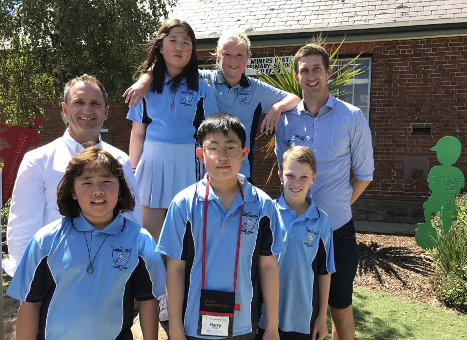 HOSTS: Miners Rest Primary School principal Dale Power, senior teacher Michael Searl  and pupils Lily and Joe take time out of class with exchange students Kate, Ju Yeon, and Harry from Sinmyeong Elementary School in Busan.
