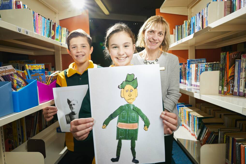 WAR STORY: St Patrick's Primary students Sam, Rose and teacher Thea Hubble research the life of Lieutenant Wilfred Salmon. Picture: Luka Kauzlaric