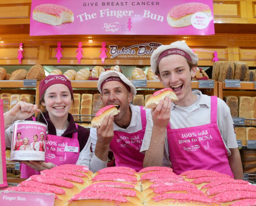 SWEET: Beth Ferguson, Glenn Drew and Bryce Waight sample the pink finger buns being sold at Bakers Delight to raise money to fight breast cancer. Picture: Kate Healy