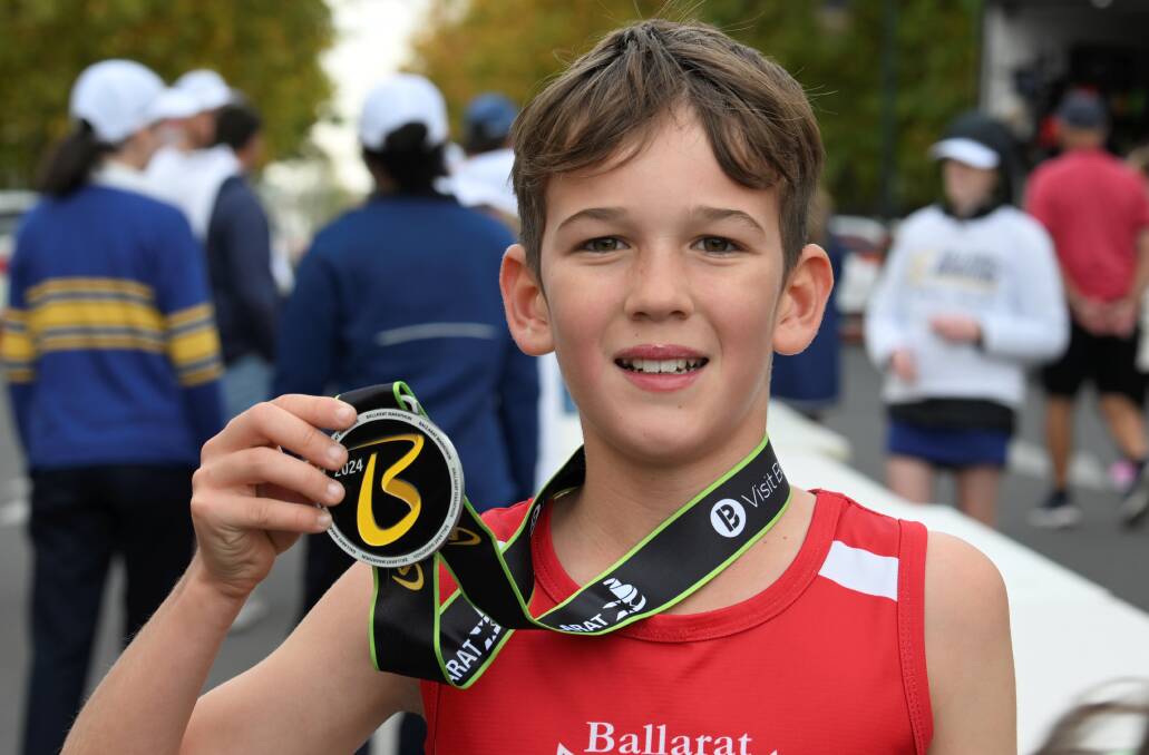 Cooper Tuddenham, 10, took on the 'big boys' in the elite men's 5km race. Picture by Lachlan Bence
