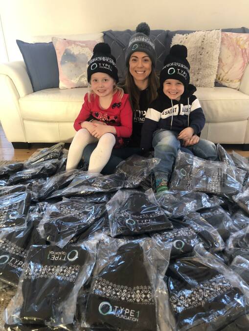 DIABETES: Naomi Glasson (centre) with Evie, 5, and Harry, 4, and the beanies they are selling to raise money for the Type 1 Foundation. Picture: supplied