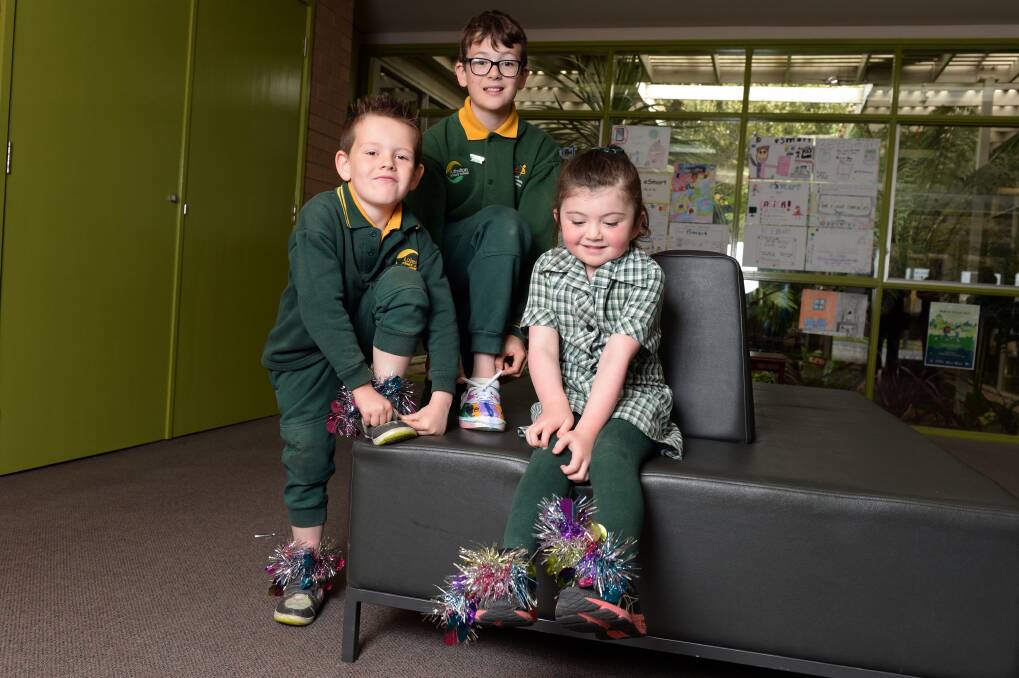 FLASHY FEET: Alfredton Primary School pupils Cohen, Harley and Amelia show off their decorated shoes for the Walk to School campaign. Picture: Kate Healy
