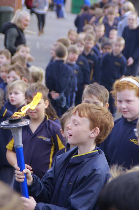 FLAME: Canadian Lead Primary School students line up to hold the Sri Chinmoy Oneness - Home Peace Run torch during its visit to the school on its way from Brisbane to Adelaide. Picture: Sarankhuu Jargal