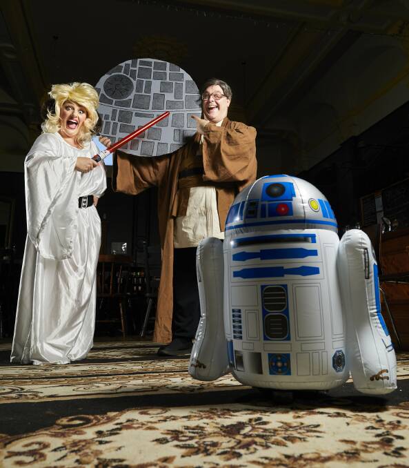 FORCEFUL: Sophie Livitsanas, Luke Tonkin and R2-D2 brush up on their Star Wars knowledge ahead of their trivia night at Suttons to celebrate the 40th anniversary of A New Hope. Picture: Luka Kauzlaric 