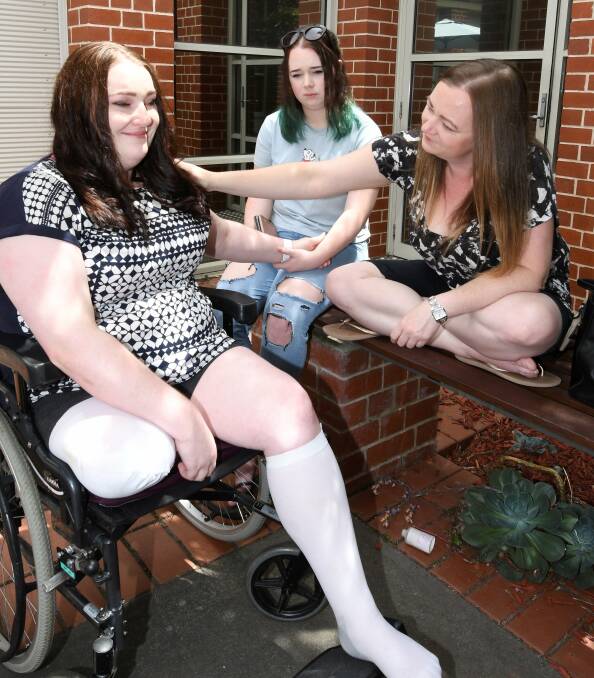 COMFORT: Amie Wemyss receives comforting support from her sister Kate and niece Hannah Wemyss-Sanderson. Picture: Lachlan Bence